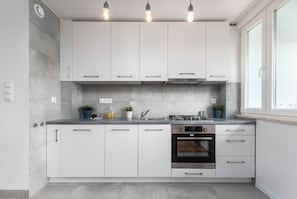 Fully equipped kitchenette with an electric  kettle, fridge freezer, gas cooktop, oven, dishwasher and toaster.