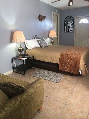 Queen bed with two lamps and two bedside tables for reading and comfort.