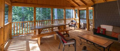 Large screened porch with porch swing. Table seats 12