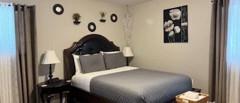 Master Bedroom, queen bed (sleeps 2), smart TV, direct access to half-bathroom