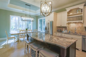 This beach home features a gourmet kitchen with granite counters, high end appliances and tiled backsplash.
