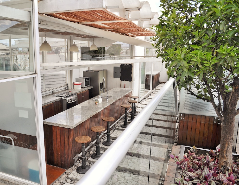 best airbnb mexico city condesa and roma norte | Rooftop restaurant outdoors at a with bar seating and a kitchen
