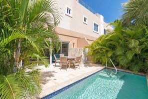 Private back patio with a swimming pool