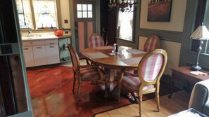 Dining room that connects to a patio with  a grill, fire pit, table and chairs