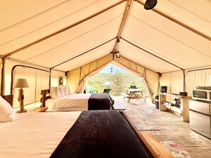 You will love the plush queen beds in our glamping tents!  You will also have access to cots if needed.  All of our glamping tents have Air Conditioning & Heat, Private Bathroom, outdoor sitting area and kitchenette.