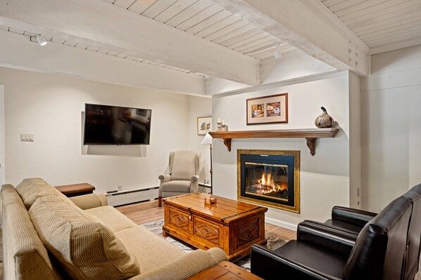 The living area with flat screen TV and gas fireplace is a perfect place to share time with your traveling companions.