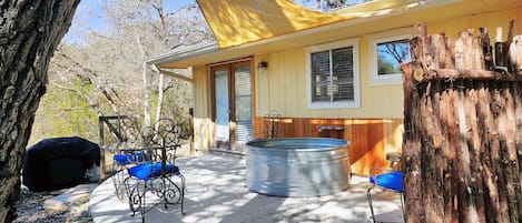 The deck features a "Hippie Hot Tub" which is a large outdoor soaking tub.
