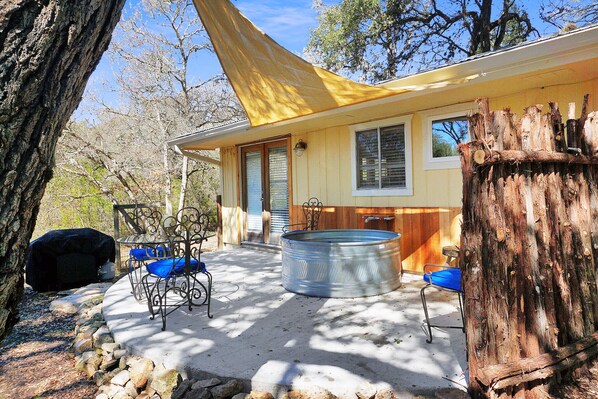 The deck features a "Hippie Hot Tub" which is a large outdoor soaking tub.