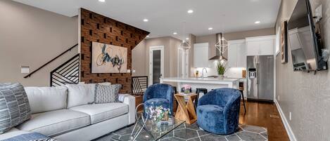 The large open concept floor plan is perfect for your large group to spread out and relax. 
The living room offers plenty of seating, a SmartTV, and opens to the gourmet kitchen.
There are custom solar blinds to block the light. Perfect a lazy morning after a late night on Broadway!