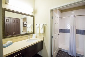 Get ready for your day in the bathroom. Please note this unit has a roll-in shower.