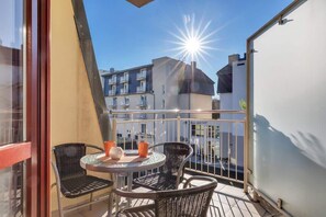 The living area opens up to a balcony, perfect for enjoying the nice vievs and air.