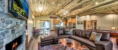 Does a great room get any greater than this?! Large HDTV, gas fireplace, leather sectional, pool table, 2 club chairs