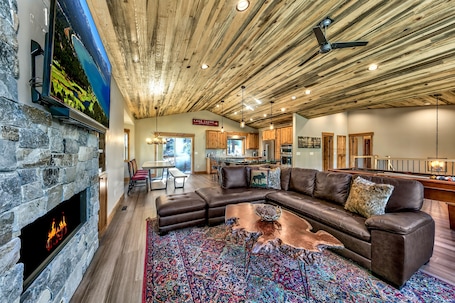 Does a great room get any greater than this?! Large HDTV, gas fireplace, leather sectional, pool table, 2 club chairs