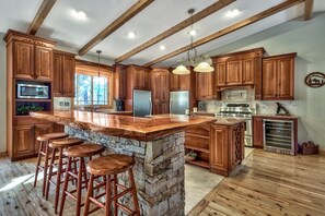 The chef of your crew will love this custom kitchen complete wit - The chef of your crew will love this custom kitchen complete with stainless steal appliances, a wine cooler, stand alone fridge & freezer, gas range, kitchen island, bar w/ 4 stools, microwave, & dishwasher