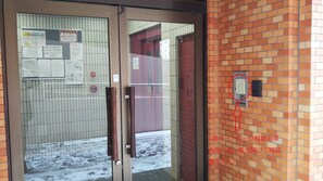 Condominium entrance on the first floor (automatic unlocking operation panel in white box on right)