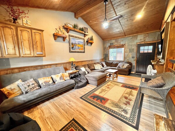Family Rm, 70’ smart TV, Ceiling fan, wall heat, futon/bedding, open to Kitchen
