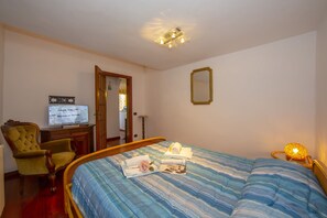 The bedroom is large and opposite the apartment's bathroom on the ground floor.