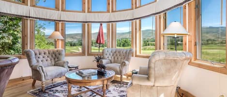 Stunning panoramic views of the golf course and mountains from the living room.