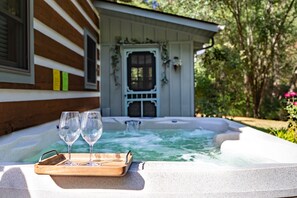 Hot tub with waterfall feature and multi light LEDs plus drink cooler.