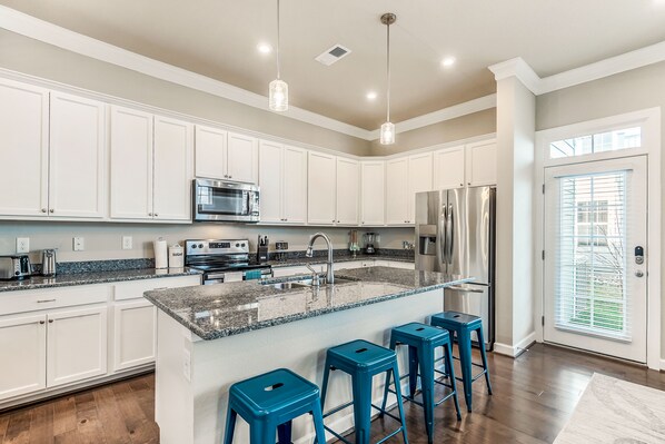 Fully stocked kitchen with a large island.