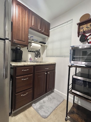 Kitchen area with full size refrigerator