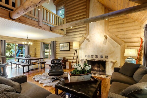 Open concept living area with seating and fireplace