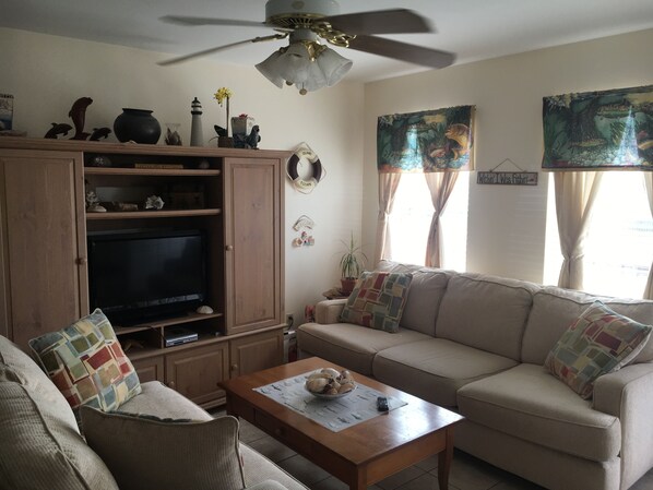 Living Area , cozy couches, table with two chairs and a bar for two bar stools.