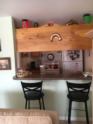 Kitchen view and bar seating.