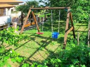 Swing, Backyard, Outdoor Play Equipment, Grass, Yard, Public Space, Playground, Garden, Plant, Play