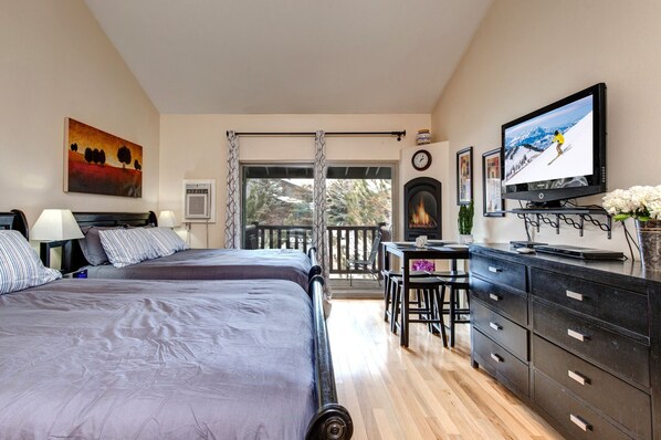 Two Queen Bed Suite: "Cozy setup with patio view, perfect for a relaxing staycation."