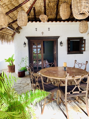 dining table for al fresco dining under lit palapa