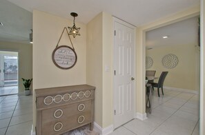 Front hall way and storage with beach chairs, towels and cooler 