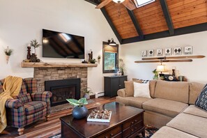 Living room with gas fireplace and large flatscreen television