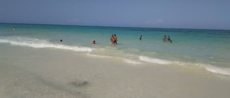 Warm water and crystal clear white sand beach. Just steps away
