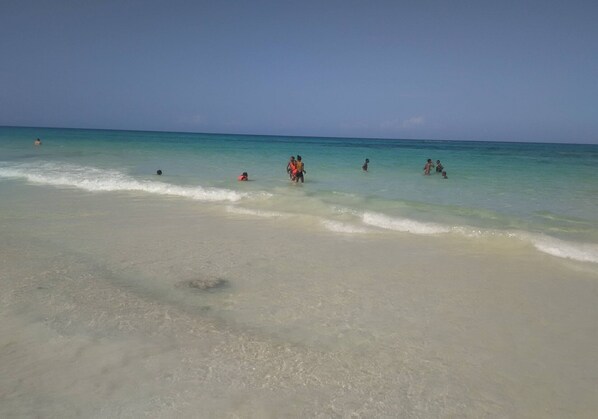 Warm water and crystal clear white sand beach. Just steps away