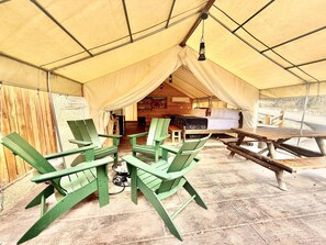 Outdoor seating with gas fire pit and BBQ grill at glamping tent 1 at East Zion Resort