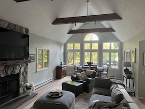 Living room with dining room table and bar, with views of the lake.