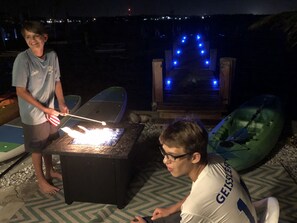 Fire pit fun with pier lights and Bradenton lights twinkling in the background