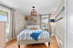 This unique bedroom has a queen bed, TV, and a large closet.