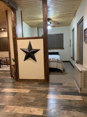 From the entryway you can go right to the master bedroom with a king-size bed.