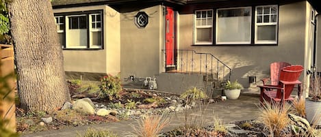 Street view & yard w/ a couple Adirondack chairs to enjoy late afternoon sun. 