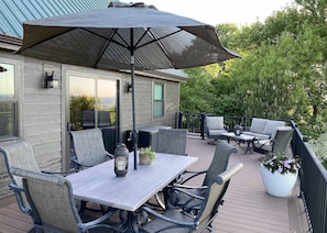 Spacious deck featuring new patio furniture and grill 