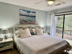 Main bedroom with partial lagoon view and king bed