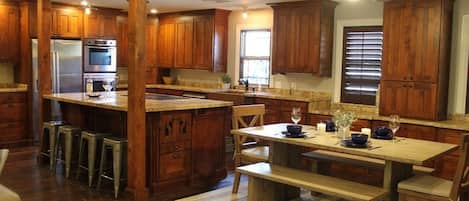 Well stocked and equipped kitchen with breakfast bench.  