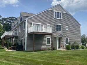 Large grassy area at the side of the house by the front entry.