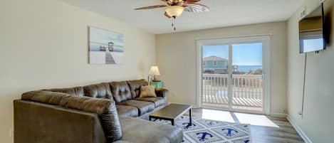 Revel in the seaside ambiance from the living room of our expansive 2-bedroom unit, perfectly located just across the street from beach access.