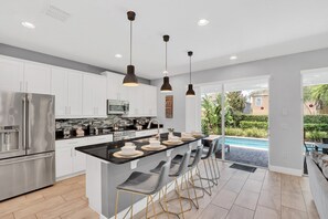 Enchanting Kitchen Area of the Apartment in Kissimmee Florida - Integrated appliances for a seamless and stylish appearance - Functional layout designed for efficient meal preparation - Breakfast Bar for convenience - Ample Natural Light