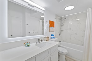 Newly renovated full bathroom with tub and shower combo.