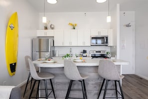 Newly redecorated kitchen with island seating and stainless steel appliances