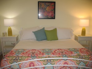 The bedroom has a flat screen tv, a large closet and hardwood floors.